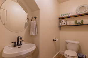 Half bath featuring a sink and toilet