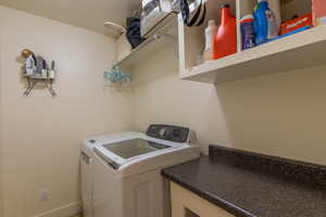 Laundry room featuring washing machine and clothes dryer and baseboards