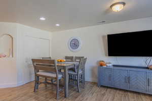 Dining room featuring light wood-style flooring and recessed lighting