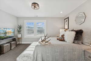 Carpeted bedroom with baseboards and recessed lighting
