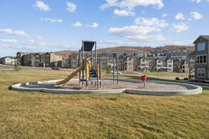 Community jungle gym featuring a residential view and a lawn