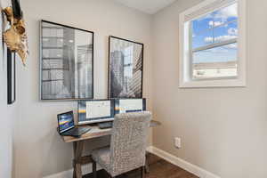 Home office featuring baseboards and dark wood finished floors