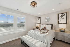 Bedroom featuring dark carpet and recessed lighting