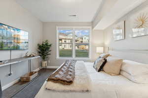 Bedroom featuring baseboards and dark wood-type flooring