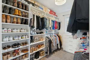 Walk in closet with light carpet
