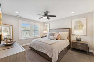 Carpeted bedroom featuring a ceiling fan and recessed lighting