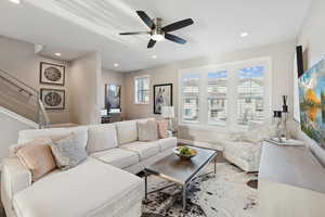 Living room featuring wood finished floors, recessed lighting, stairs, and ceiling fan