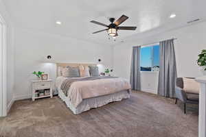Carpeted bedroom featuring a ceiling fan and recessed lighting