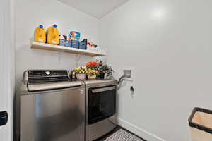 Washroom with baseboards and independent washer and dryer