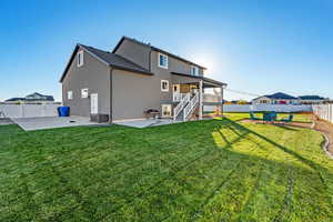 Rear view of house with a patio area, a fenced backyard, stairs, and stucco siding