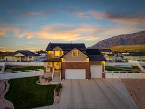 Craftsman-style home featuring board and batten siding, brick siding, roof mounted solar panels, concrete driveway, and a residential view