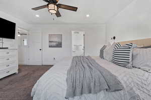 Bedroom featuring dark carpet, recessed lighting, a ceiling fan, and connected bathroom