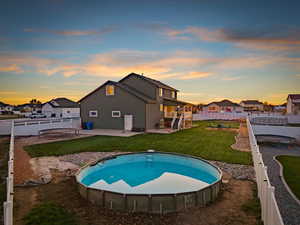 Swimming pool with a patio, a fenced backyard, and a residential view