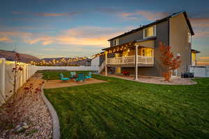 Rear view of house featuring a fenced backyard, a patio, stairs, stucco siding, and a wooden deck