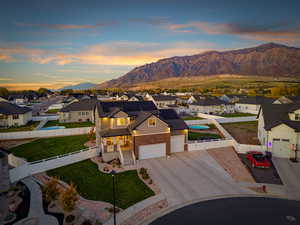 View of front of house with a residential view, a gate, a fenced backyard, brick siding, and driveway