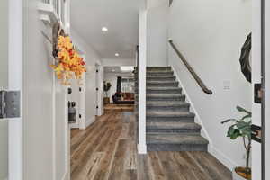 Entryway featuring recessed lighting, dark wood-style floors, and stairway