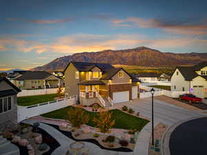 View of front facade with a residential view, brick siding, a mountain view, and driveway