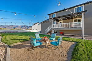 Rear view of house with a patio, stucco siding, a deck with mountain view, and stairway