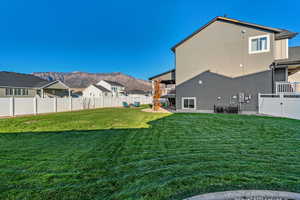 Fenced backyard featuring a patio, a mountain view, a residential view, and a balcony