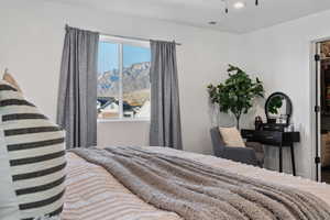 Bedroom featuring a walk in closet, a mountain view, and recessed lighting