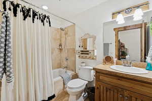 Full bath featuring tiled shower / bath, vanity, and light tile patterned floors