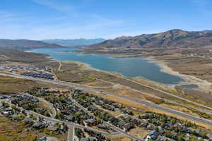 Aerial overview of property's location with a water and mountain view and nearby suburban area