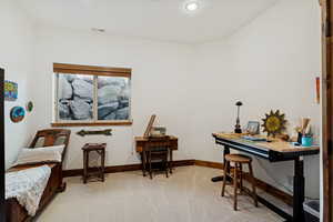 Living area featuring light colored carpet and recessed lighting