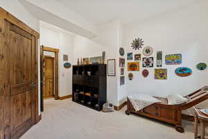 Bedroom featuring light colored carpet and baseboards