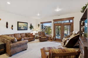 Living room with carpet, french doors, and recessed lighting