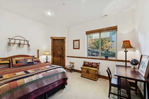Carpeted bedroom featuring baseboards
