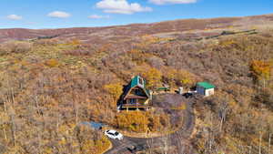 Aerial view of property and surrounding area featuring a heavily wooded area