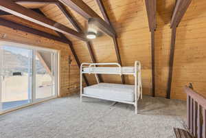 Bedroom featuring wood ceiling, light colored carpet, access to exterior, and wooden walls