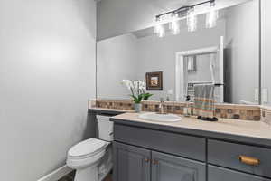 Bathroom featuring vanity and toilet