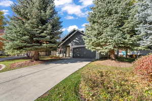 Obstructed view of property featuring driveway and an attached garage