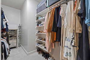 Spacious closet with light carpet