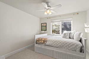 Bedroom featuring light carpet and a ceiling fan