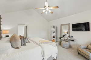Bedroom featuring light colored carpet, high vaulted ceiling, and a ceiling fan
