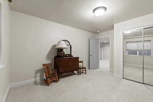 Bedroom featuring light colored carpet and a closet