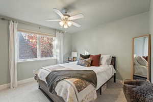 Bedroom featuring light carpet and a ceiling fan
