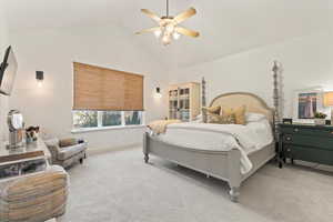 Bedroom with carpet floors, high vaulted ceiling, and ceiling fan