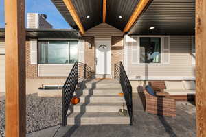 Entrance to property featuring brick siding and crawl space