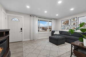 Living room with recessed lighting and light wood-style flooring