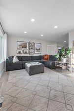 Living room featuring light wood-style floors and recessed lighting