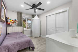 Bedroom with recessed lighting, light wood-type flooring, ceiling fan, and a closet