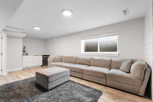 Living room with light wood-style floors and wine cooler
