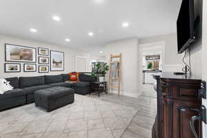 Living room with recessed lighting and light wood-type flooring