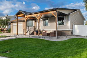 View of front of home featuring an outdoor living space, an attached garage, a porch, and concrete driveway