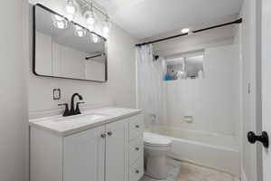 Full bathroom with shower / bath combo with shower curtain and vanity