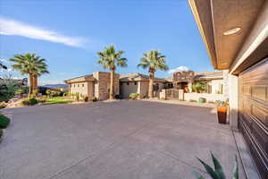 View of front facade with a gate and stucco siding