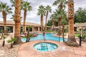 Community pool with a community hot tub and a patio